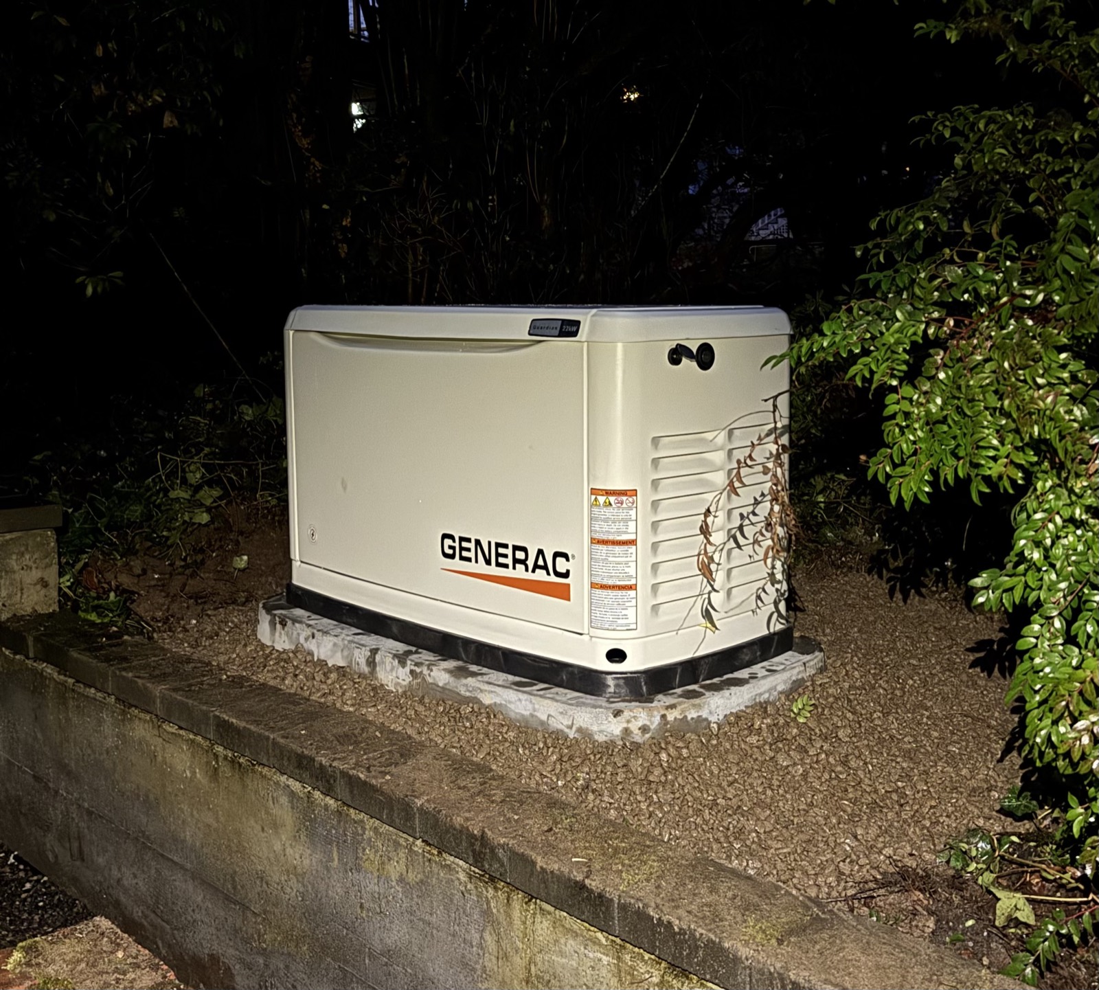 Generac Guardian 22kW standby generator installed on its pad — night photo after commissioning