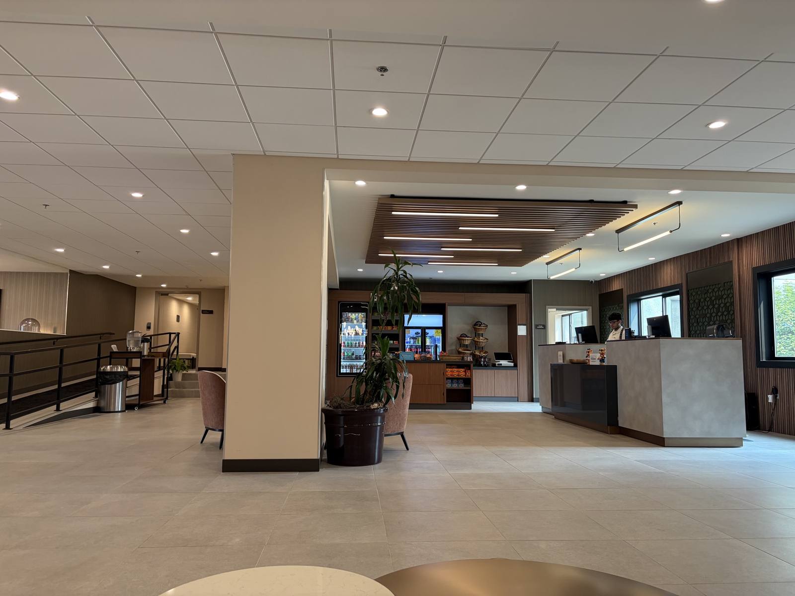 Renovated Hilton Garden Inn lobby with wood-slat feature ceiling and new front desk