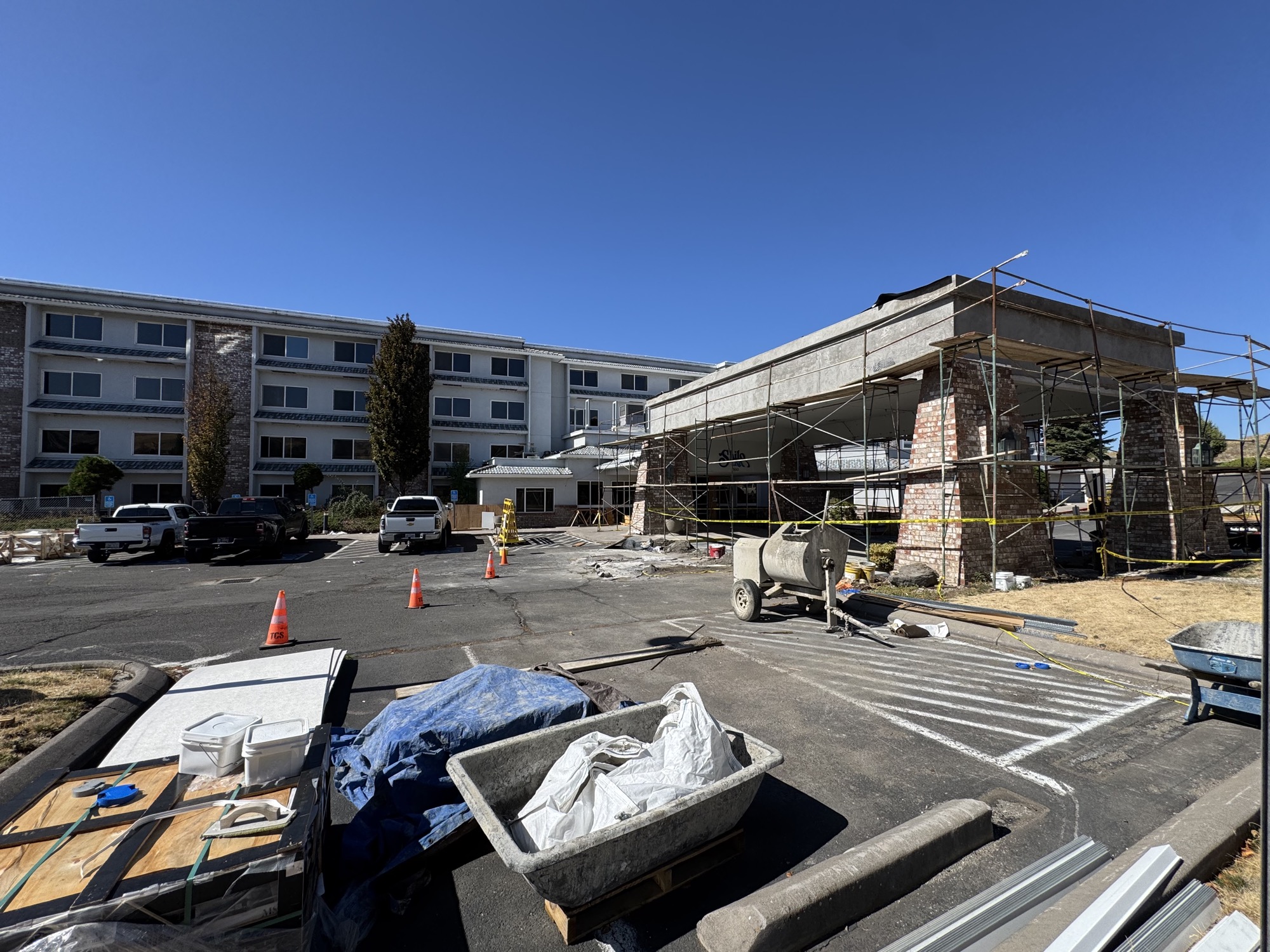 Hotel entrance porte-cochère under scaffolding during the dual-brand conversion